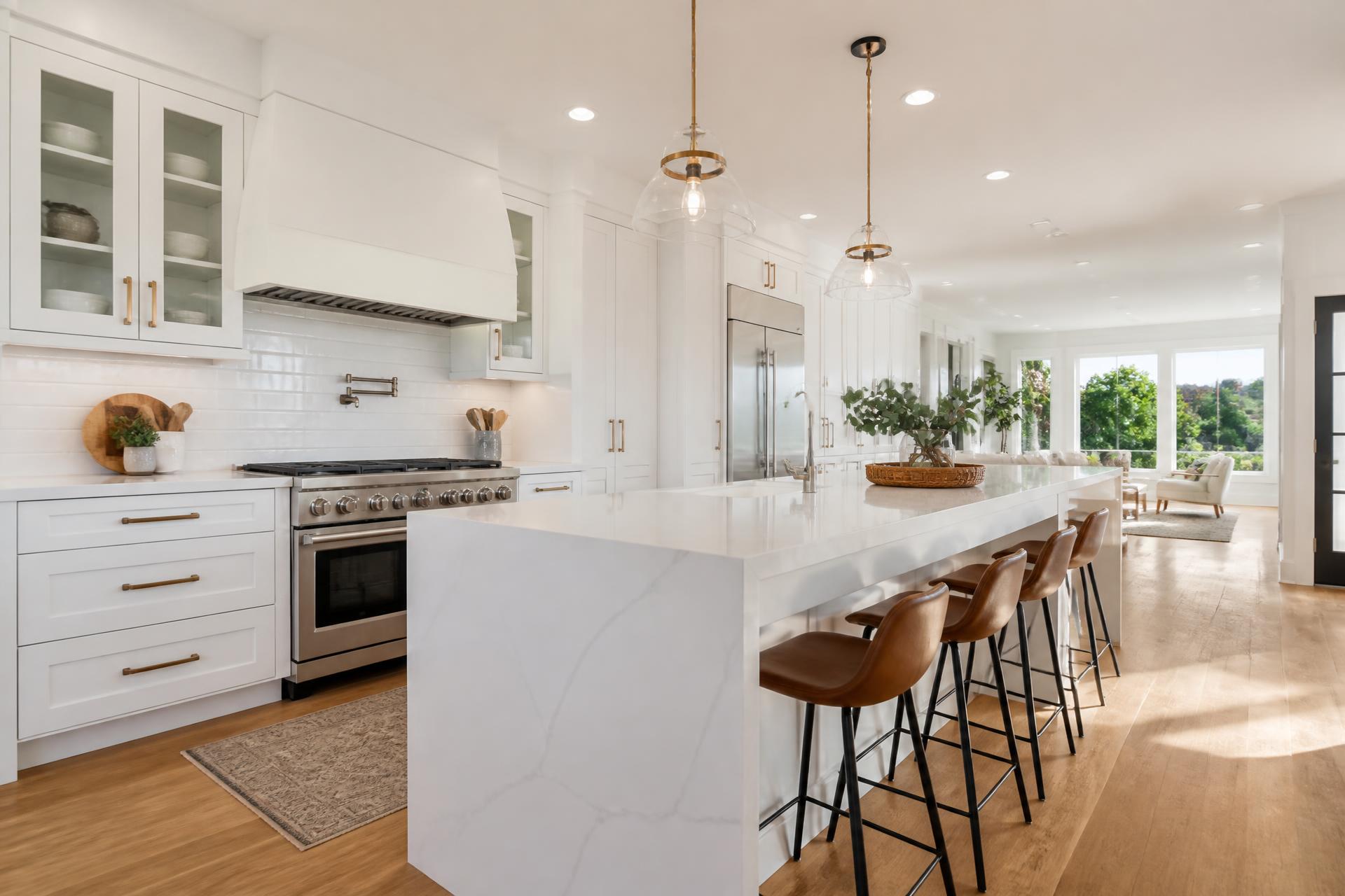Modern remodeled kitchen with white cabinets and quartz island